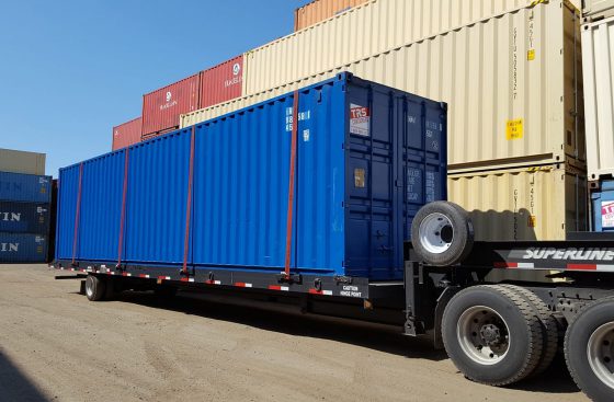 Shipping container being delivered by truck