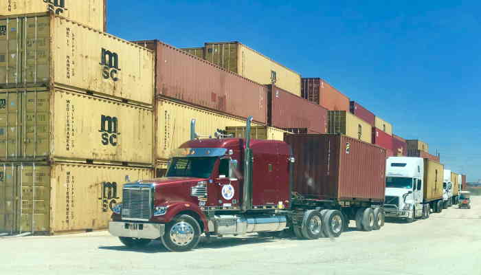Shipping containers for sale stacked at a depot